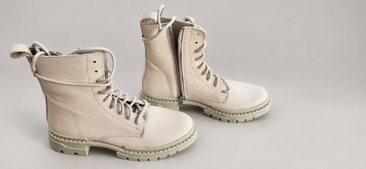 Steve Madden light combat boots on professional studio background